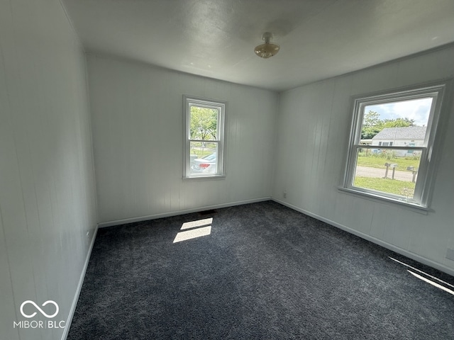 1914 E 23rd St, Muncie, IN 47302 - spare room with dark carpet and baseboards