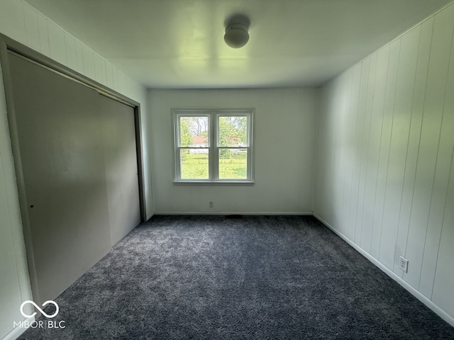 1914 E 23rd St, Muncie, IN 47302 - unfurnished bedroom with dark colored carpet and a closet