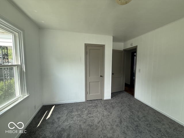 1914 E 23rd St, Muncie, IN 47302 - unfurnished bedroom with multiple windows and carpet