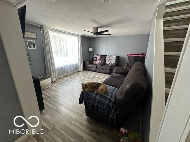 1129 Lafayette St, Elkhart, IN 46516 - living area with ceiling fan, wood finished floors, and a textured ceiling