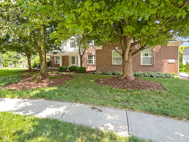 12089 Red Hawk Dr, Fishers, IN 46037 - view of property hidden behind natural elements with brick siding and a front lawn