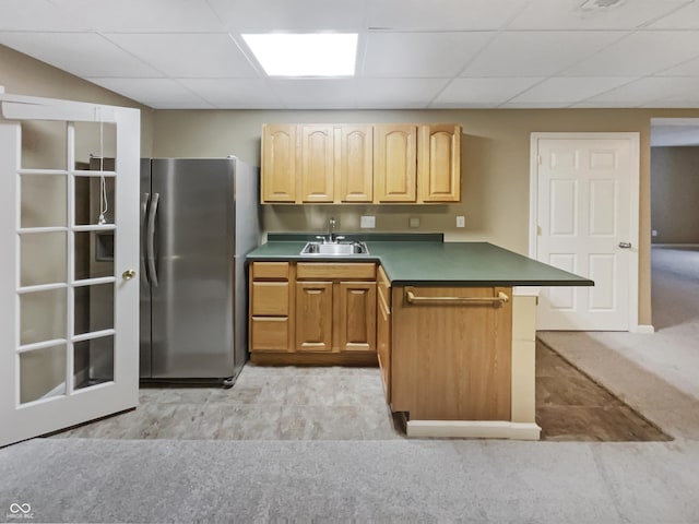 12089 Red Hawk Dr, Fishers, IN 46037 - kitchen featuring a peninsula, freestanding refrigerator, dark countertops, light colored carpet, and a drop ceiling