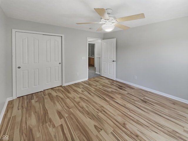 12089 Red Hawk Dr, Fishers, IN 46037 - unfurnished bedroom with light wood-style floors, a closet, and a ceiling fan