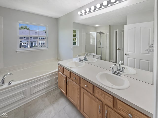 12089 Red Hawk Dr, Fishers, IN 46037 - full bathroom featuring a bath, a shower stall, double vanity, a textured ceiling, and tile patterned flooring