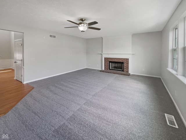 12089 Red Hawk Dr, Fishers, IN 46037 - unfurnished living room featuring ceiling fan, carpet flooring, and a fireplace