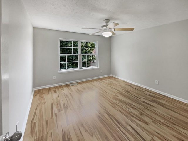 12089 Red Hawk Dr, Fishers, IN 46037 - empty room with wood finished floors, ceiling fan, and a textured ceiling