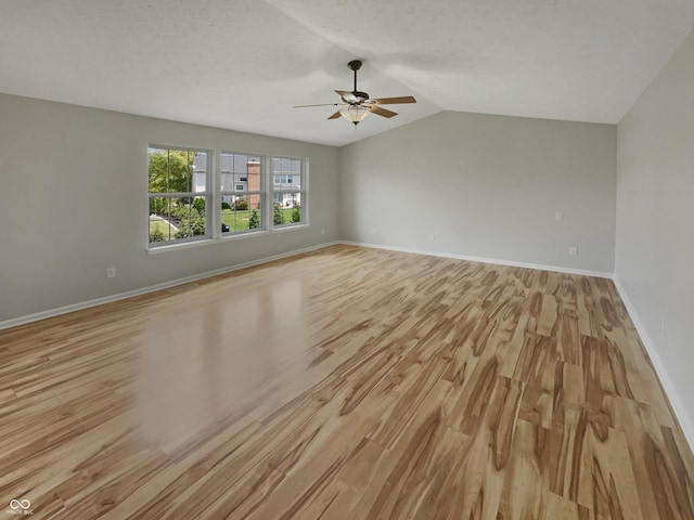12089 Red Hawk Dr, Fishers, IN 46037 - unfurnished room with ceiling fan, light wood-style floors, vaulted ceiling, and a textured ceiling