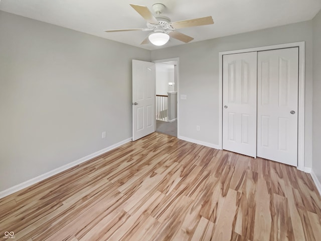 12089 Red Hawk Dr, Fishers, IN 46037 - unfurnished bedroom with light wood-style floors, a closet, and a ceiling fan