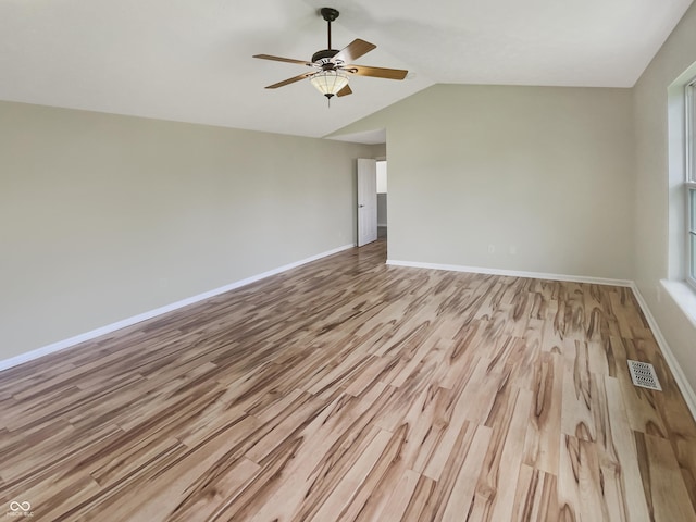 12089 Red Hawk Dr, Fishers, IN 46037 - spare room featuring wood finished floors, ceiling fan, and lofted ceiling