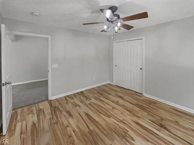 12089 Red Hawk Dr, Fishers, IN 46037 - unfurnished bedroom featuring light wood-style floors, a closet, and a ceiling fan
