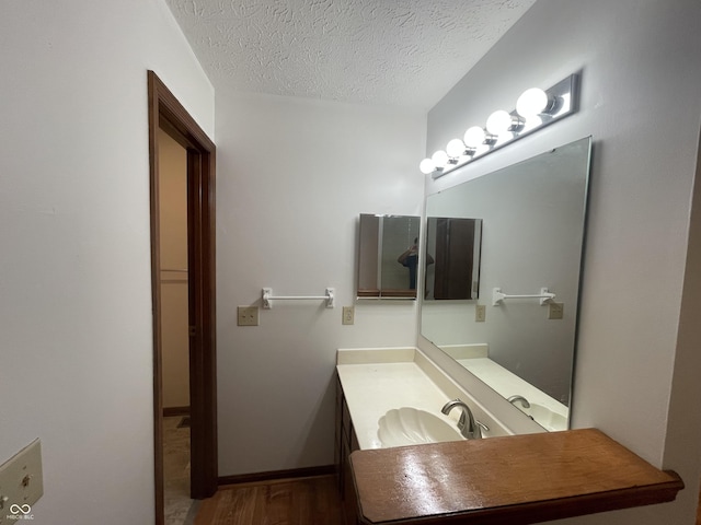10610 Stillcreek Dr, Indianapolis, IN 46239 - bathroom with vanity, a textured ceiling, and wood finished floors
