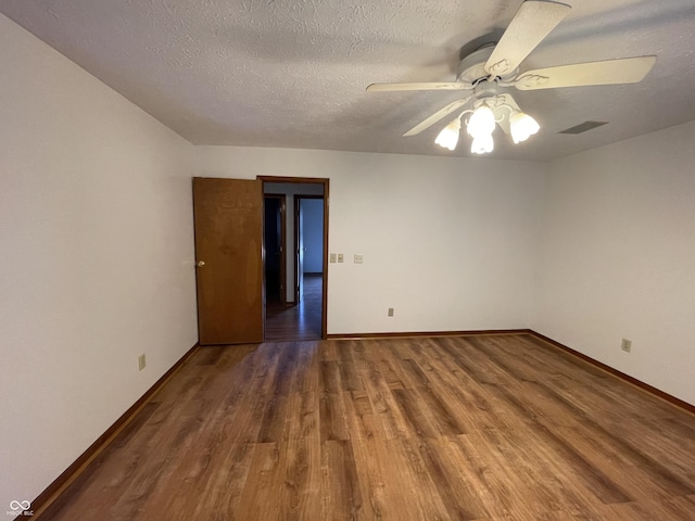 10610 Stillcreek Dr, Indianapolis, IN 46239 - empty room with wood finished floors, ceiling fan, and a textured ceiling