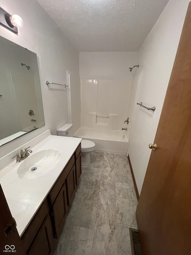 10610 Stillcreek Dr, Indianapolis, IN 46239 - bathroom featuring vanity, a textured ceiling, bathtub / shower combination, and marble look tiles