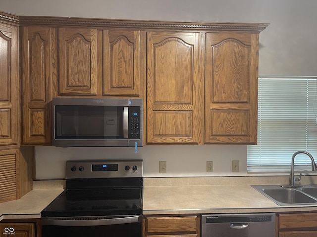 10610 Stillcreek Dr, Indianapolis, IN 46239 - kitchen with appliances with stainless steel finishes, light countertops, and brown cabinetry