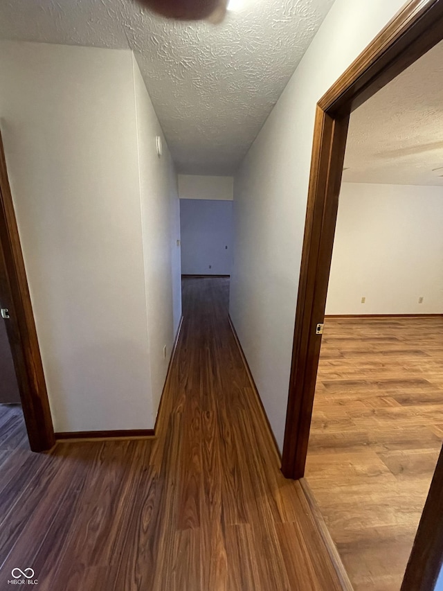 10610 Stillcreek Dr, Indianapolis, IN 46239 - hall featuring wood finished floors and a textured ceiling
