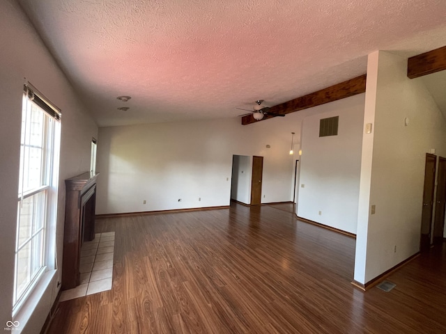 10610 Stillcreek Dr, Indianapolis, IN 46239 - unfurnished living room with a textured ceiling, ceiling fan, dark wood-style flooring, and beam ceiling
