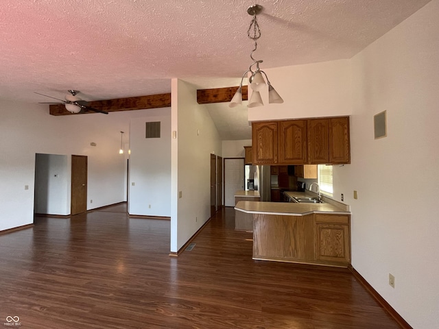 10610 Stillcreek Dr, Indianapolis, IN 46239 - kitchen featuring a textured ceiling, dark wood-style flooring, ceiling fan, brown cabinets, and open floor plan