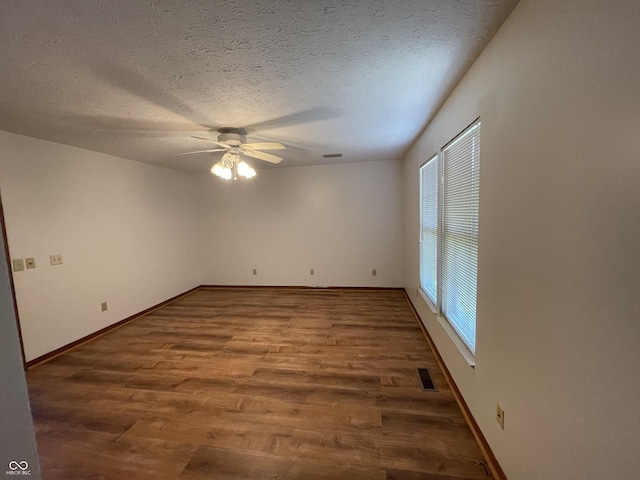 10610 Stillcreek Dr, Indianapolis, IN 46239 - spare room with a ceiling fan, wood finished floors, and a textured ceiling