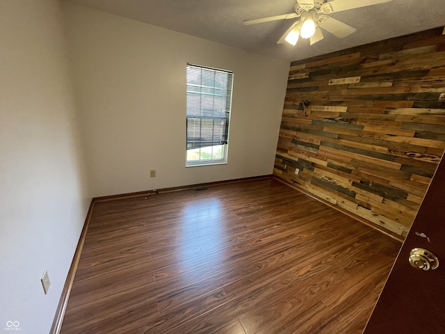 10610 Stillcreek Dr, Indianapolis, IN 46239 - spare room with dark wood-style floors, a ceiling fan, and wood walls