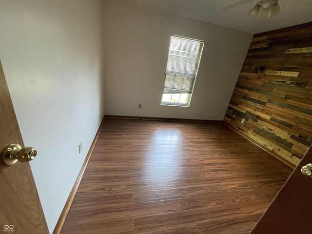 10610 Stillcreek Dr, Indianapolis, IN 46239 - empty room featuring wood finished floors, ceiling fan, and wood walls