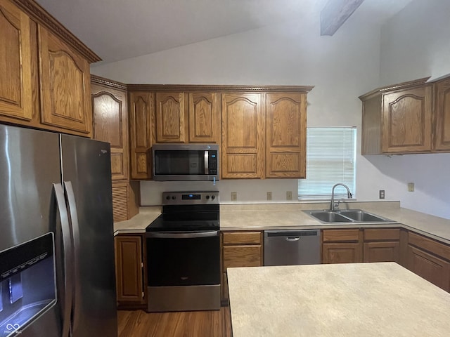 10610 Stillcreek Dr, Indianapolis, IN 46239 - kitchen with stainless steel appliances, vaulted ceiling, light countertops, dark wood finished floors, and brown cabinets