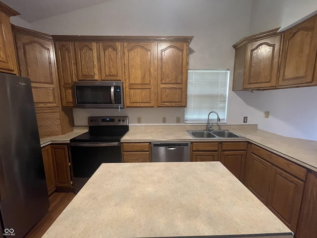 10610 Stillcreek Dr, Indianapolis, IN 46239 - kitchen with stainless steel appliances, lofted ceiling, light countertops, and brown cabinetry