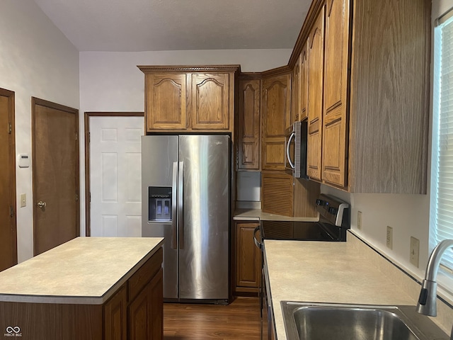10610 Stillcreek Dr, Indianapolis, IN 46239 - kitchen with stainless steel appliances, light countertops, dark wood-style floors, a center island, and brown cabinetry
