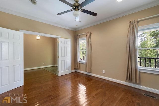 unfurnished bedroom featuring ceiling fan, dark wood-type flooring, and ornamental molding