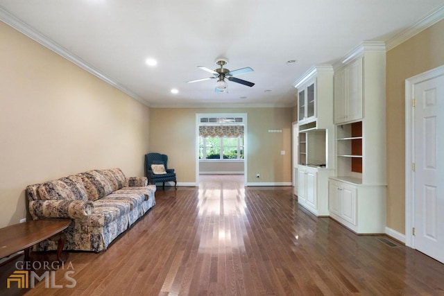 living room with ceiling fan, crown molding, and dark hardwood / wood-style floors