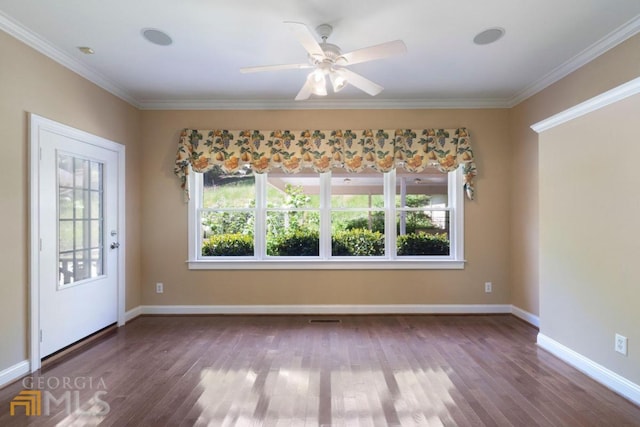 unfurnished room with ceiling fan, dark wood-type flooring, and crown molding