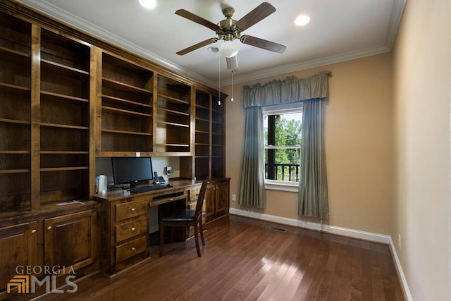 unfurnished office with ceiling fan, ornamental molding, dark hardwood / wood-style floors, and built in desk