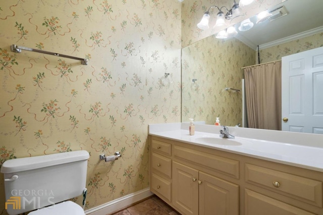 bathroom with toilet, tile floors, vanity, and crown molding