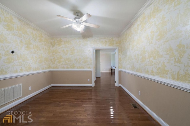 unfurnished room with ornamental molding, ceiling fan, and dark wood-type flooring