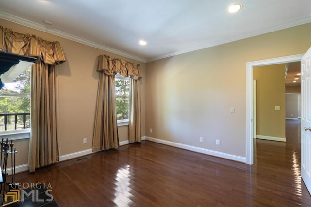 empty room with dark wood-type flooring and crown molding