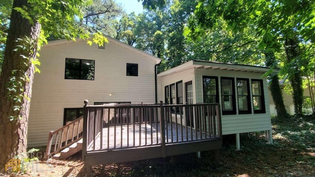 back of property featuring a deck