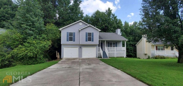 tri-level home with a front yard, covered porch, and a garage