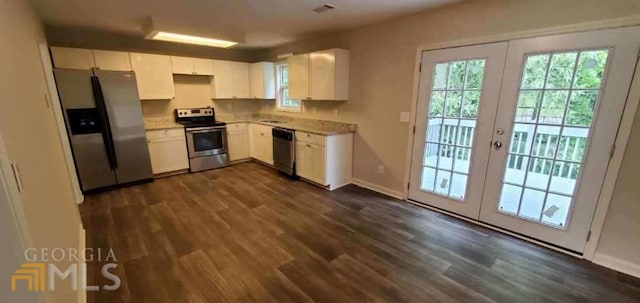 kitchen featuring white cabinets, stainless steel appliances, dark hardwood / wood-style floors, and french doors