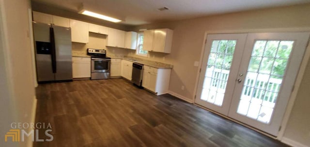 kitchen featuring dark hardwood / wood-style flooring, stainless steel appliances, white cabinetry, and french doors