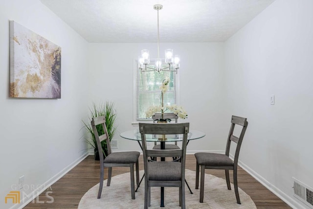 dining space featuring a chandelier and dark hardwood / wood-style flooring