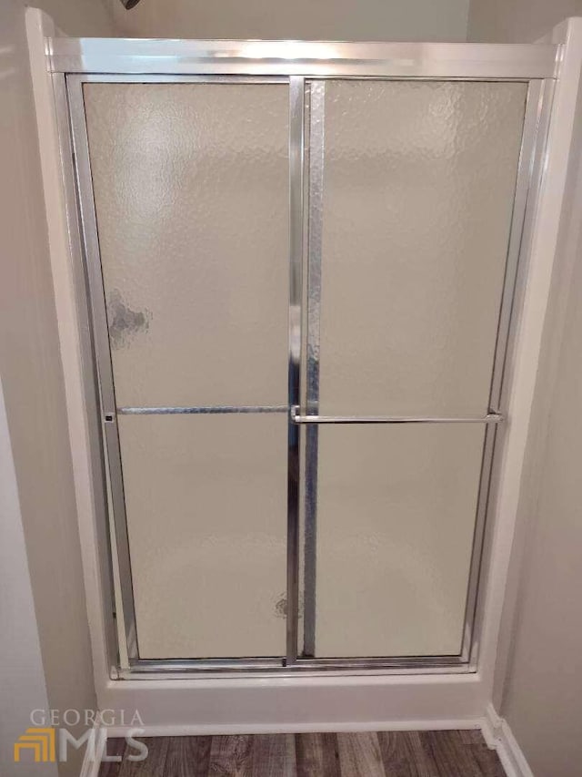 1208 Bordeau Way, Villa Rica, GA 30180 - bathroom featuring an enclosed shower and wood-type flooring