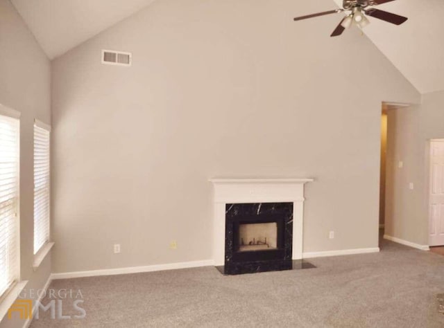 1208 Bordeau Way, Villa Rica, GA 30180 - unfurnished living room featuring ceiling fan, a high end fireplace, dark colored carpet, and high vaulted ceiling