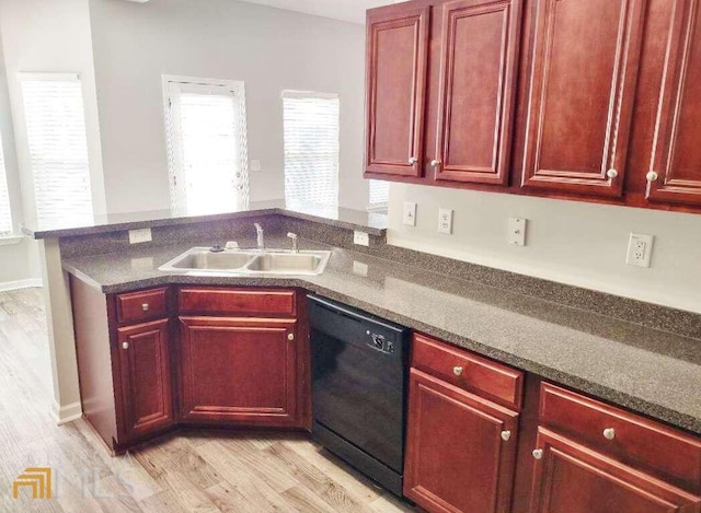 1208 Bordeau Way, Villa Rica, GA 30180 - kitchen featuring dark stone countertops, light hardwood / wood-style flooring, dishwasher, and sink