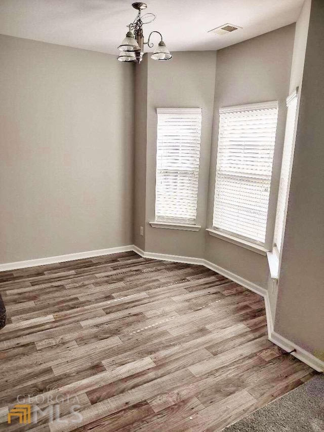 1208 Bordeau Way, Villa Rica, GA 30180 - empty room with dark hardwood / wood-style flooring and a notable chandelier