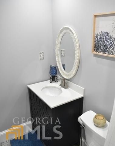 bathroom featuring toilet and vanity