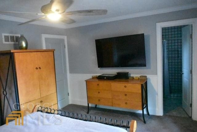 bedroom with carpet flooring, ceiling fan, and crown molding