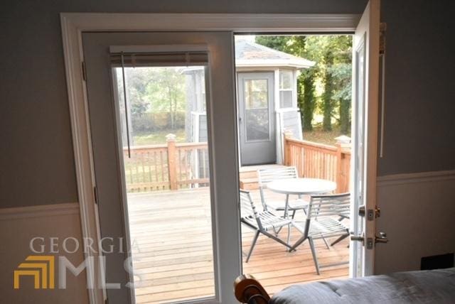 doorway with hardwood / wood-style flooring