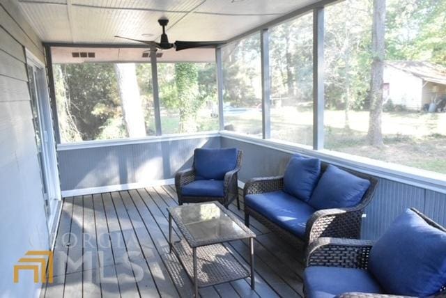 sunroom featuring ceiling fan