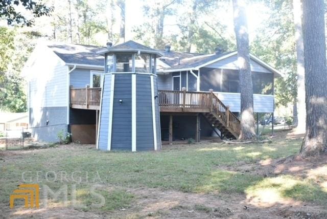 back of house featuring a deck and a sunroom