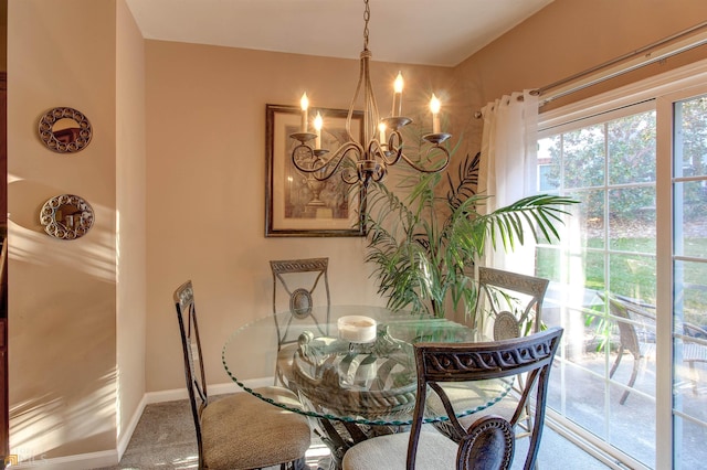 dining space featuring carpet floors and a notable chandelier