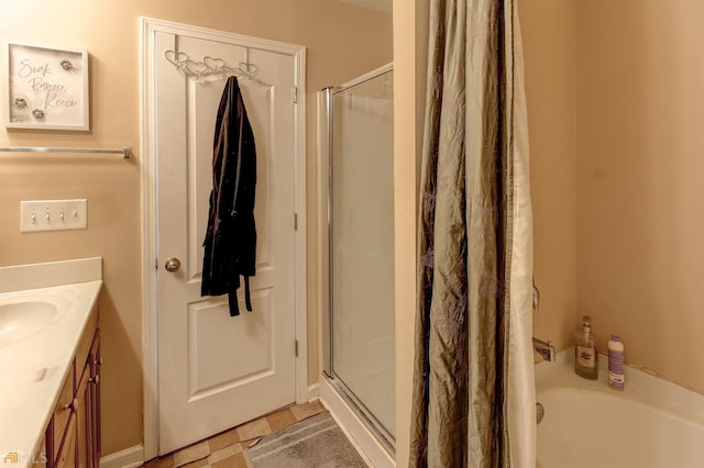 bathroom with tile flooring, vanity, and independent shower and bath